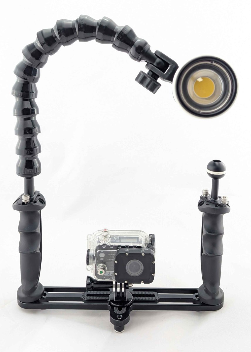 Single-light action-camera rig with a dual-handle tray, segmented flexible arm and camera in a clear housing.